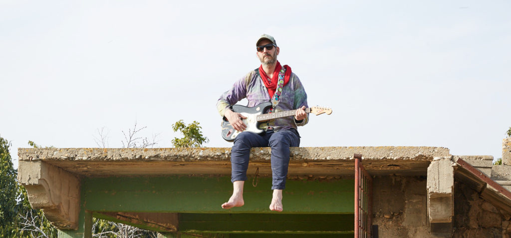 Sivan Langer on a roof banner